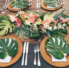 a table set with place settings and flowers