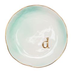 a green and white plate with the letter d on it