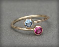 This gorgeous ring is made using two manmade gemstones or synthetic opals, that have been set in tube bezels. This ring is slightly adjustable. Handcrafted from 14k gold-filled. Please refer to photo for birthstone and opal color choices. • sold individually• 14k gold-filled, manmade gemstones, synthetic opal• stones: 4mm• band width: 1.3mm Don't know your ring size? Purchase a Reusable Ring Sizer *This is a made to order item. Please check the announcement at the top of the page for current pro Dual Birthstone Ring, Cute Promise Rings, Mother's Ring, Birthstone Ring Mothers, Mothers Ring, Colored Stone Rings, Mother Rings, Synthetic Opal, Opal Color