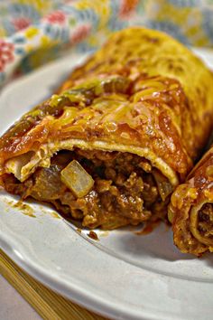 a burrito cut in half on a plate