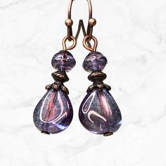 Purple iridescent teardrop beads with a soft luster and hints of blue pair up with copper accents in these beautiful Czech glass earrings.  Exceptional beads for everyday wear or dress up.  Lightweight earrings are easy to wear all day. Best seller.  Hypoallergenic ear wires (nickel and lead free). Choose ear wire style at checkout. Longer version: https://www.etsy.com/listing/1349683659/purple-long-earrings-purple-copper Also available in GREEN: https://www.etsy.com/listing/1331047177/green-woo Iridescent Drop Earrings For Jewelry Making, Iridescent Teardrop Crystal Earrings, Elegant Iridescent Beaded Earrings For Gift, Iridescent Czech Glass Dangle Earrings, Elegant Handmade Iridescent Beaded Earrings, Iridescent Beaded Drop Earrings, Hypoallergenic Teardrop Czech Glass Earrings, Hypoallergenic Czech Glass Teardrop Earrings, Iridescent Round Beads Earrings With Ear Wire