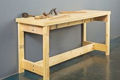 a workbench made out of wood with tools on it