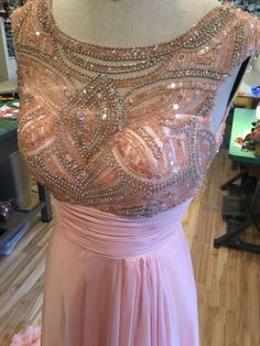 a dress on display in a store with lots of beading and sequins