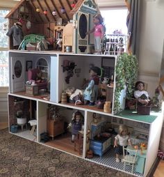 a doll house with dolls and furniture in it