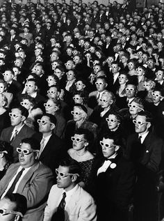 a large group of people wearing masks and sitting in front of each other with the words estamos ciecos de realdad