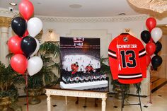 the hockey jersey is on display in front of balloons