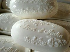 several white soaps stacked on top of each other with the words love written on them