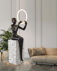 a statue with a ring around it's neck sitting in front of a couch