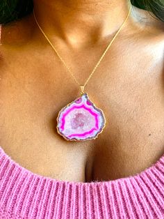 "Vivica" Experience the unique beauty of nature with this large pink geode necklace. With its bold, captivating color and stunning natural crystal formation, it is sure to make a statement and turn heads. Stand out and show off your unique style with this one-of-a-kind geode necklace! 11" Long Pendant: 2" x 1 3/4" 14k Gold-filled Chain Pink Necklace With Large Pendant, Unique Pink Necklace With Large Pendant, Unique Pink Jewelry With Large Pendant, Pink Gemstone Jewelry With Mineral Crystal, Pink Pendant Crystal Necklace With Natural Stones, Unique Pink Gemstone Necklace, Pink Agate Pendant Necklace, Pink Agate Pendant Jewelry, Pink Agate Necklace Gift