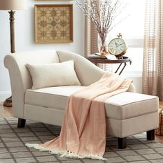 a living room with a couch, chair and clock