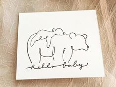 a card with the words hello baby written in cursive writing on it and an image of a bear