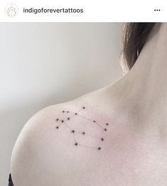 a woman's chest with small stars on it