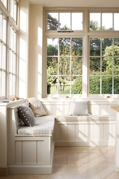 a white couch sitting in front of a window