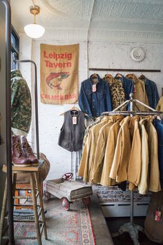 an old fashion clothing store with clothes hanging on racks