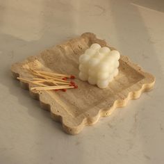 a small tray with some chopsticks and marshmallows on top of it