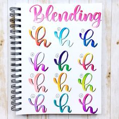 a spiral notebook with the word blending written in different colors and letters on top of it