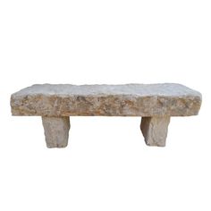 a stone bench sitting on top of a white wall