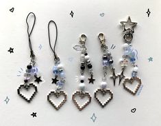 five different earrings are shown on a white surface with stars and hearts in the background