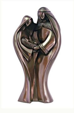 a bronze statue of two people hugging each other