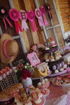 a table topped with lots of cakes and desserts