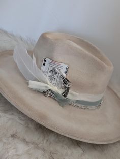 Beautiful and feminine wide brim vegan suede rancher hat.  Hand burned edges to look aged.  Soft fabric chiffon ribbon bands layered with a rhinestone cording band.   Playing card and rhinestone pistol tack pin!   This is a Vegan Suede Rancher Hat in tan color -hand burned to look aged This hat is one size fits most, Medium,  with an elastic inner band to fit size 55-59cm or  7 - 7¼  This hat is ready to ship. Please note: Due to the handmade nature of these size and color may slightly vary. Handmade by @TeresaLovesCrafts in Torrance, CA If you have any questions or special requests in regard to your order, please feel free to message me prior to order. Thanks for stopping by and supporting my small business. xo, Teresa Find me on Instagram : https://www.instagram.com/teresa.loves.crafts Band Playing, Chiffon Ribbon, Rancher Hat, Chapeau Cowboy, Hat Custom, Cowgirl Hats, Cow Girl