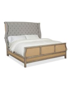 a bed with an upholstered headboard and foot board on top of it