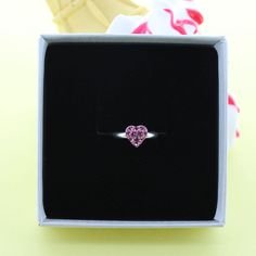 A cute sparkly sterling silver ring with a little pink cubic zircon heart. The cute sterling silver ring would be a perfect gift. The ring can be adjusted to different sizes. Each piece arrives in a beautiful White gift box with a contrasting silver logo. A free gift wrapping service is also available upon request. Pink Heart Ring For Mother's Day Gift, Pink Rings For Mother's Day Gift, Pink Heart Ring With Birthstone For Promise, Pink Heart Birthstone Ring For Promise, Pink Heart Birthstone Ring, Heart Cut Pink Birthstone Promise Ring, Dainty Pink Heart Promise Ring, Proposal Sterling Silver Heart Ring, Silver Heart Ring With Birthstone For Proposal