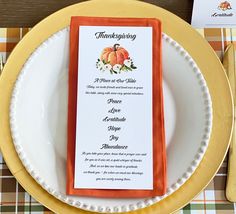 a thanksgiving dinner menu on a plate with gold rimmed place mats and orange napkins