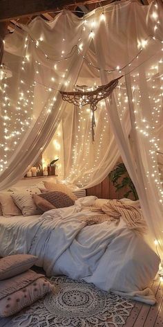 a bed covered in white sheets and lights