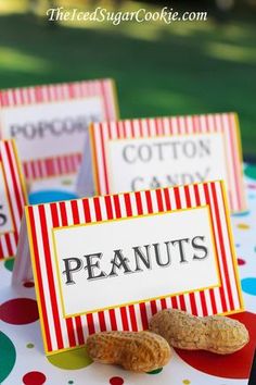 some peanuts are sitting on top of a table with red and white striped napkins