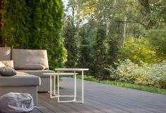 a white couch sitting on top of a wooden deck