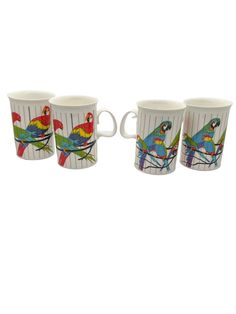 four coffee cups with parrots on them are sitting next to each other in front of a white background