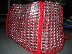 a red and silver bag sitting on top of a table