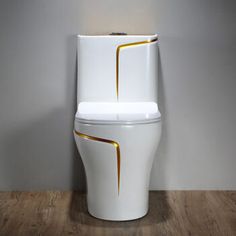 a white toilet sitting on top of a hard wood floor next to a gray wall