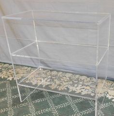 a clear acrylic display case sitting on top of a rug