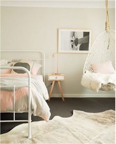 a bedroom with a hammock hanging from the ceiling