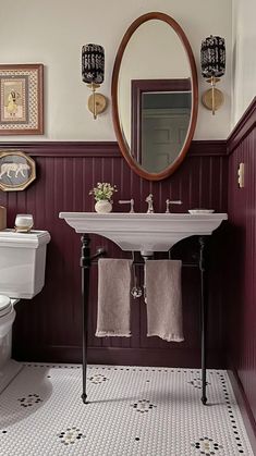 a white sink sitting under a mirror in a bathroom