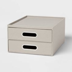 a white box with two drawers sitting on top of it