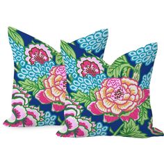 two blue and pink floral pillows on a white background, one has a large flower pattern