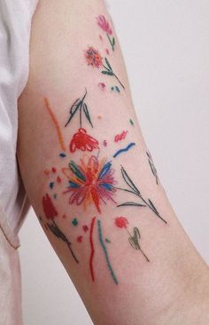 a woman's arm with flowers painted on it