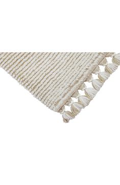 a white and beige rug with fringes on the bottom, in front of a white background