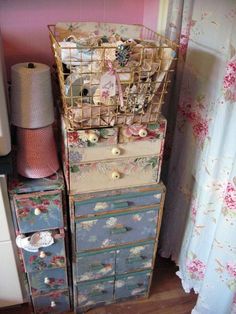 a birdcage is sitting on top of an old dresser