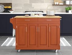 a kitchen island cart with wood top in a kitchen