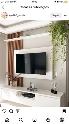 a flat screen tv mounted to the side of a white entertainment center in a living room