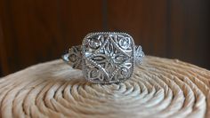 "The item is a sterling silver filigree diamond ring. The ring weighs 2.6 grams and is a finger size 7. The top part of the ring measures 11 millimeters wide and the bottom part of the ring measures 2 millimeters wide. The seven diamonds weigh .05 carats. The diamonds are a \"G\" color and \"SI2\" clarity. I can adjust the size on it . I will provide a ring box with the ring." Formal Silver Filigree Ring With Intricate Design, Heirloom Silver Filigree Ring With Intricate Design, Silver Filigree Ring With Intricate Design For Formal Occasions, Silver Elegant Engraved Promise Ring, Elegant Silver Engraved Promise Ring, Formal Sterling Silver Filigree Ring With Intricate Design, Elegant Stamped 925 Filigree Wedding Ring, Elegant Sterling Silver Filigree Diamond Ring, Elegant Sterling Silver Ring With Intricate Design