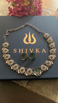 Simply Elegant! One-of-a-kind antique designer piece by Shivka! The gorgeous collar necklace is Purely handmade by our skilled Indian craftsmen from Jaipur in brass , red stones and antique polish. The pretty earrings add to the vintage look of the necklace  You will definitely fall in love with the beautiful carvings on the brass metal. The necklace comes with a hook closure and is adjustable  Diameter of Studs: 2 cms Silver Brass Meenakari Necklace, Festive Brass Necklace With Antique Finish, Handmade Round Temple Necklace For Festive Occasions, Festive Antique Finish Brass Necklace, Brass Round Temple Necklace, Green Oxidized Temple Jewelry, Vintage Temple Necklace With Oxidized Finish, Green Temple Jewelry Style Necklaces, Vintage Temple Necklace With Oxidized Finish As Gift