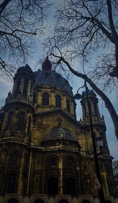 an old building with trees in front of it