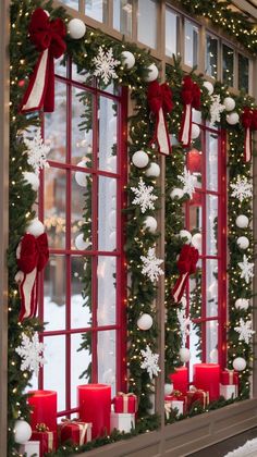 a window decorated with christmas decorations and candles