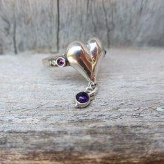 From Porans New collection ----> Unique Sterling Silver Ring. the heart center, 2 tiny Amethyst on the sides, and hanging Amethyst stone Dimensions: Max Width: 0.6 inches (0.88 inches including the hanging zircon) Can be any size you need. available with other stones! Please contact me with any questions. VISIT our silver watches shop: http://www.etsy.com/shop/PoransWatches our jewelry shop on Etsy: http://www.etsy.com/shop/Porans Thank you for Visiting Our shops Please visit my shop policies fo Heart Shaped Sterling Silver Amethyst Ring Gift, Sterling Silver Heart Shaped Amethyst Ring For Gift, Heart-shaped Sterling Silver Amethyst Ring Gift, Sterling Silver Heart-shaped Amethyst Ring, Heart Shaped Amethyst Ring In Sterling Silver, Heart-shaped Amethyst Ring In Sterling Silver, Heart-shaped Sterling Silver Amethyst Birthstone Ring, Heart-shaped Amethyst Birthstone Ring In Sterling Silver, Sterling Silver Heart Ring With Birthstone