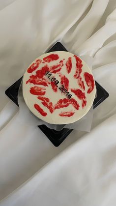 a white cake with red hand prints on it